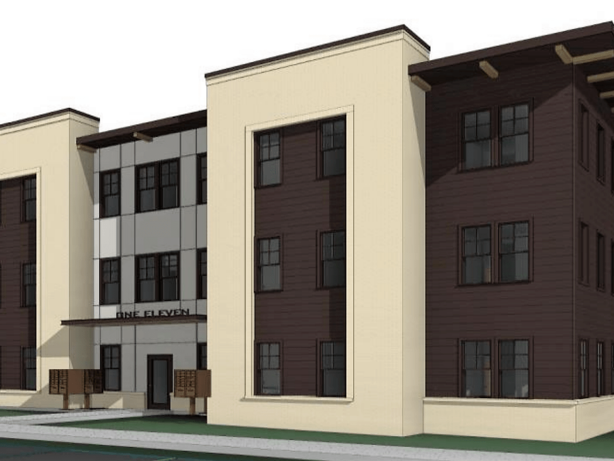An early rendering shows a three-story, brown and tan apartment block.