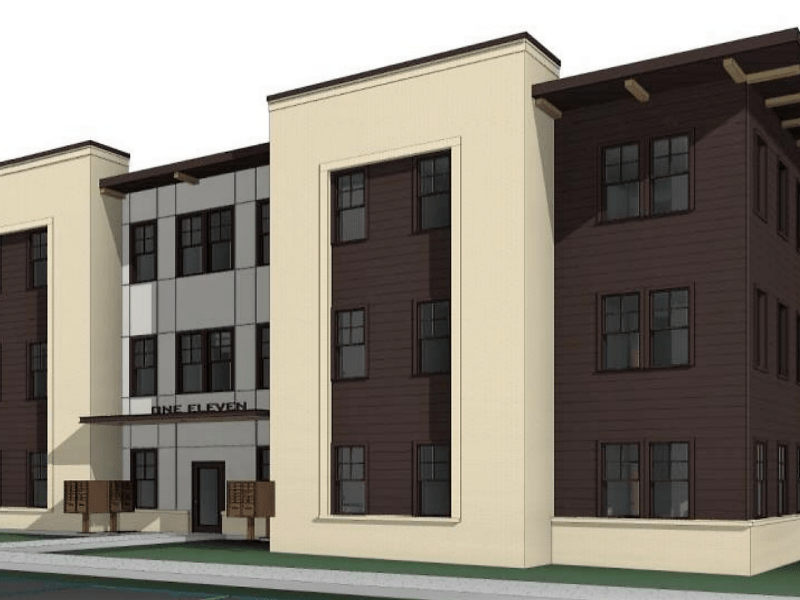 A rendering shows a three-story, brown and tan apartment block.
