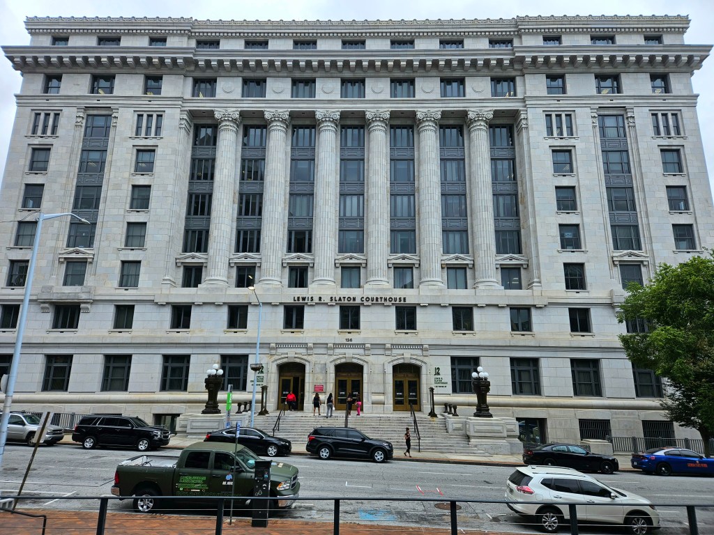 A photgraph of the Fulton County courthouse, a tall grey building with large columns.