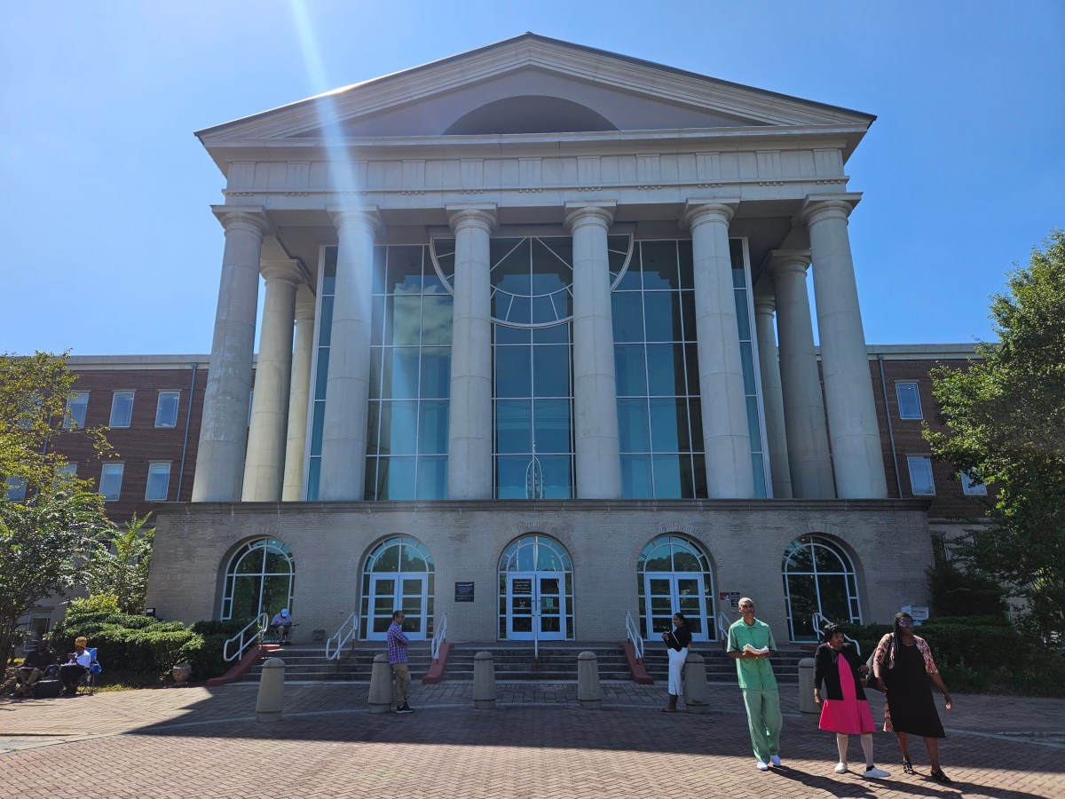 A photograph of the Clayton County courthouse, with tall white columns leading up into a gabled roof.