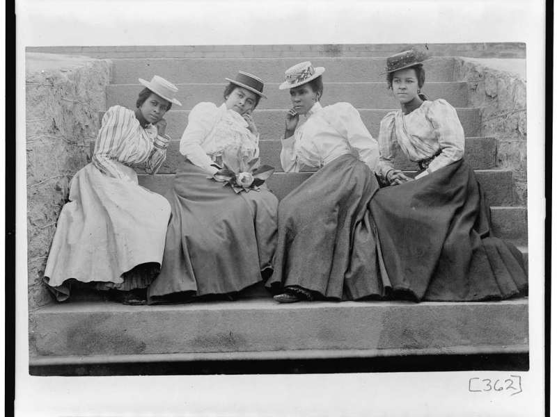 Four African-American women sitting on the steps of Atlanta University