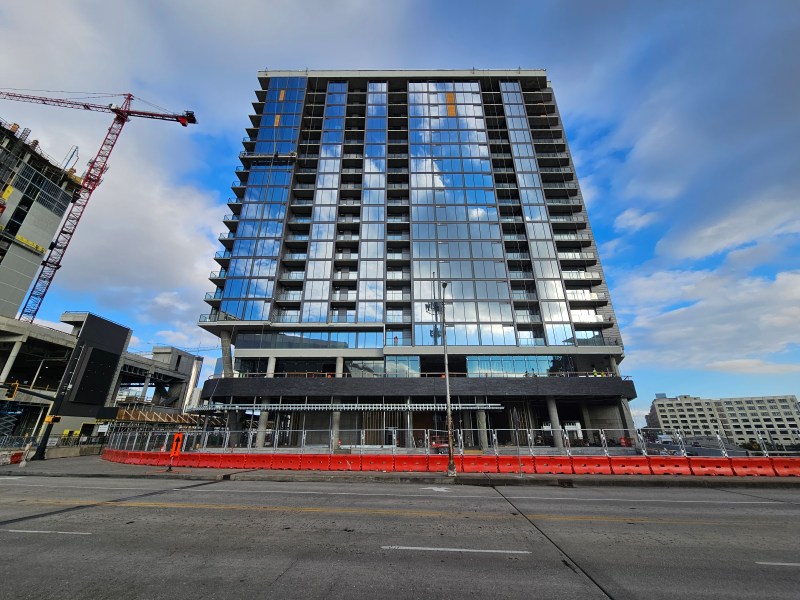 A photo of The Mitchell, a glassy high-rise being built downtown.