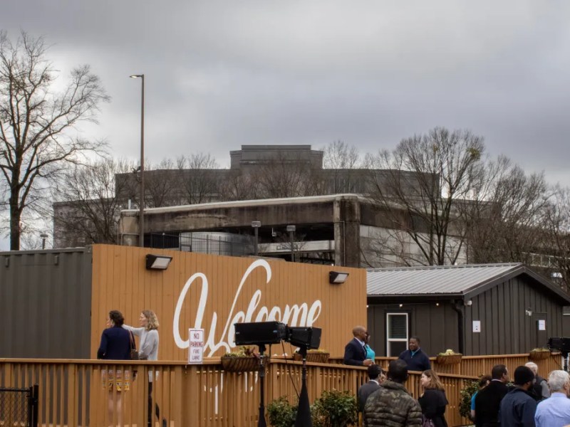 A photo of The Melody, with the Atlanta City Detention Center towering in the background.