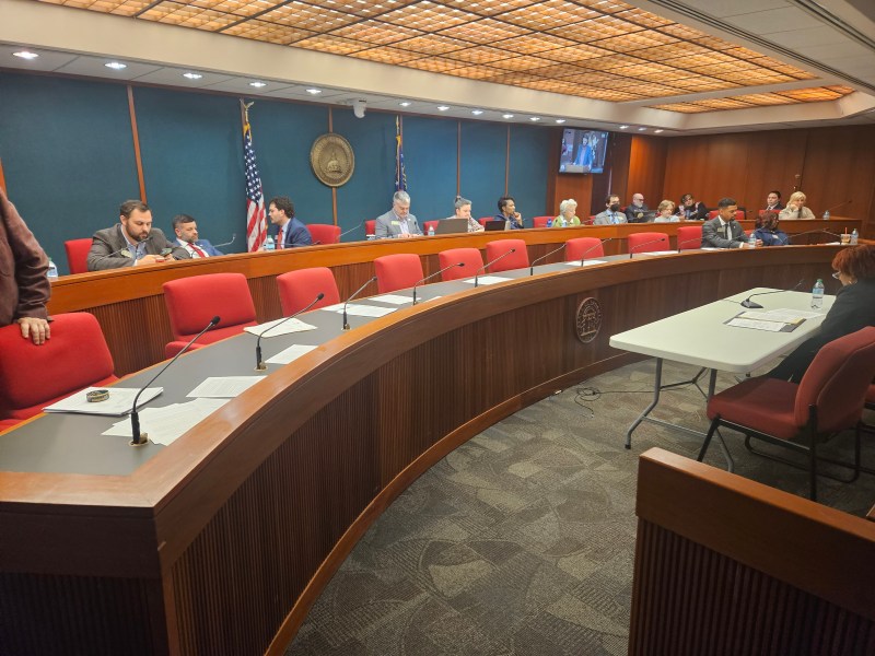 A photo of a panel of politicians sitting in a committee room.