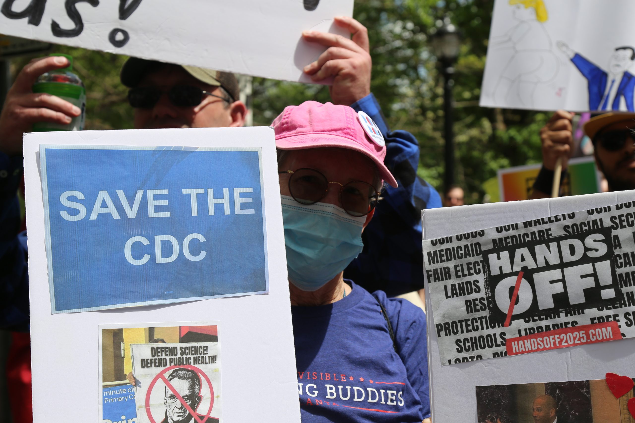 Retired Librarian Susan Fraysse poses for a picture with her signs. Credit: Alessandro Marazzi Sassoon