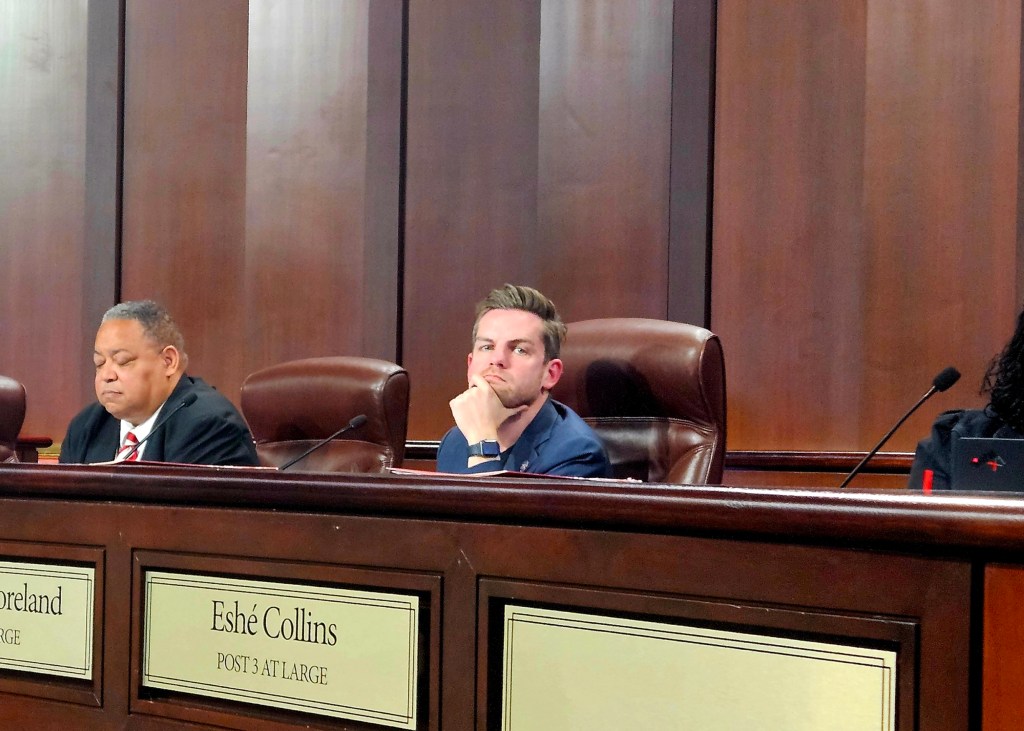 A photo of Matt Westmoreland, looking pensive while sitting in the city council chambers.