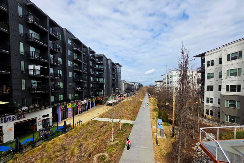 A photo of the Beltline's Eastside Trail, with new apartments towering over the path.