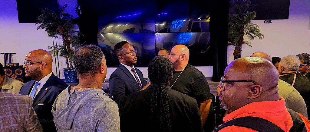 A photo of Courtney English speaking with Campbellton Road neighbors.